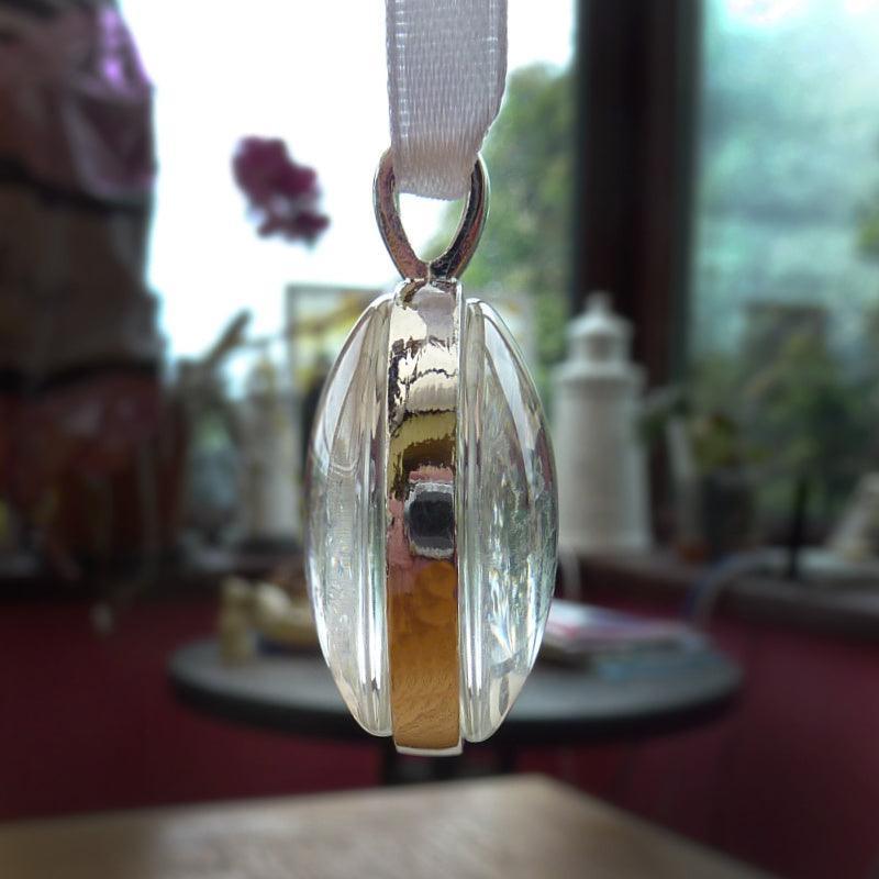 a photo on each side of the memorial charm for a wedding.