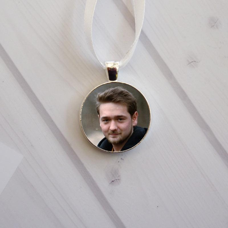 A silver bridal charm with photo on either side, an ideal keepsake.