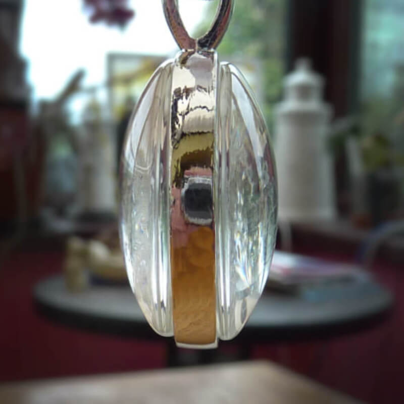 Photo necklace with one photo on each side. This circular silver necklace comes with a silver chain.