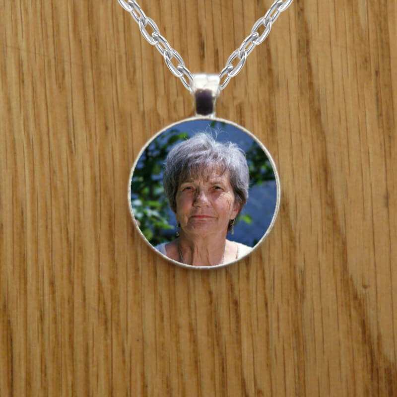 Silver necklace with two pictures inside, on a silver chain. This is hand made in Ireland with fast delivery.