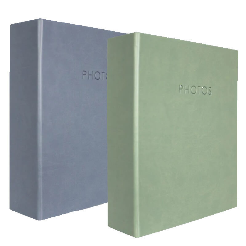 Two photo albums, one blue and one green, on a white background from Photome.ie, Irlenad's lone stop shop for photo albums.