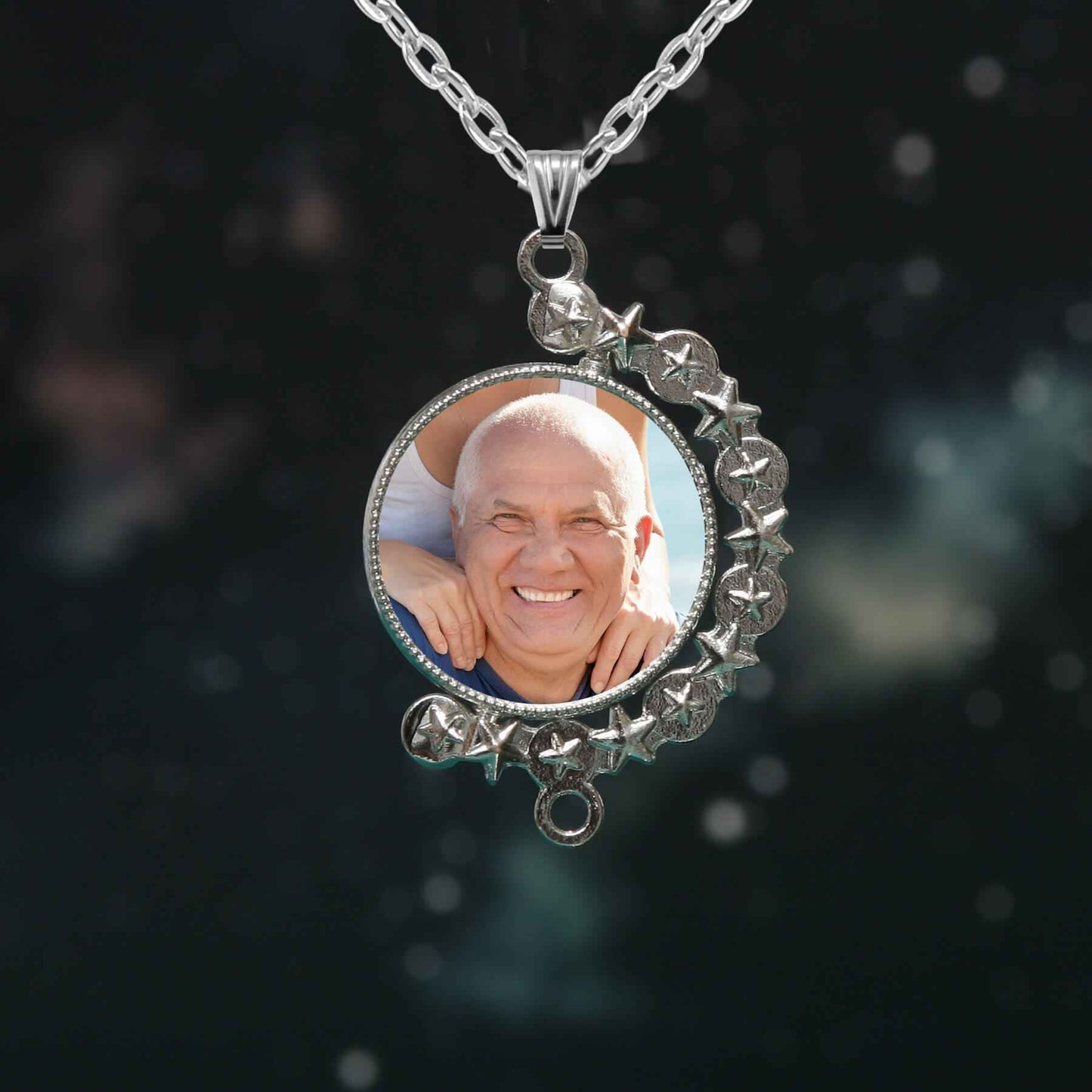 Personalised photo necklace with two photos on each side, in a rhinestone setting, on a silver chain.