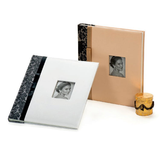 Two wedding photo albums with marble and beige covers, featuring black and white photos of a woman, on a white background.