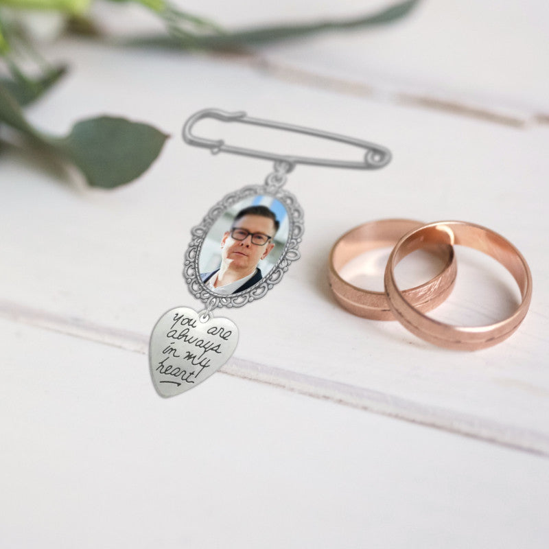 Wedding memorial brooch pin on wood surface with wedding rings, hand made in Sligo, Ireland.